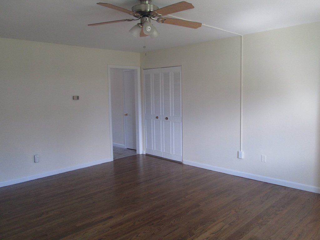 119 Colonial Circle, Unit B Chicopee, MA 01020 - Photo 6 of 17 a view of an empty room with wooden floor