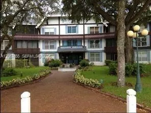 a front view of a house with a garden and plants