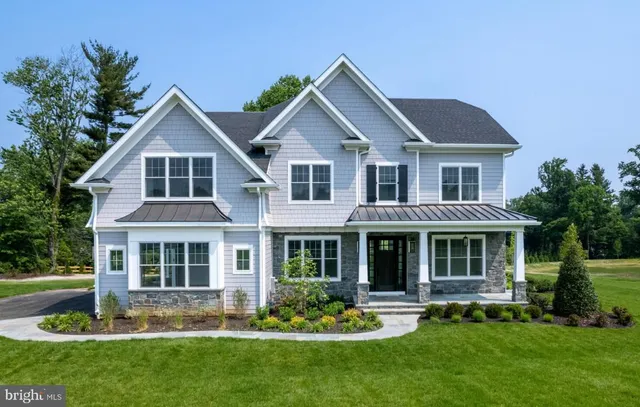 a front view of a house with a yard and porch
