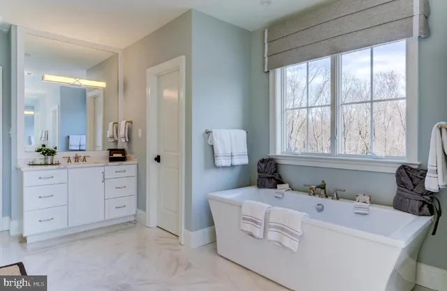 a spacious bathroom with sink and mirror