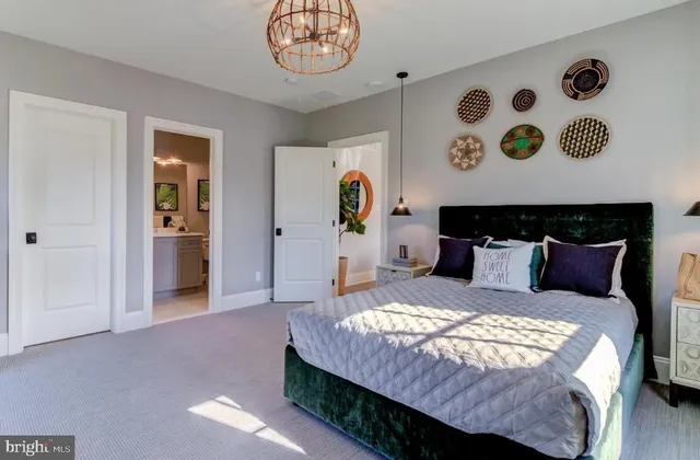 a bedroom with a bed and a chandelier