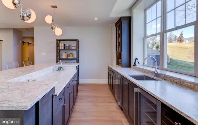 a bathroom with a granite countertop sink and a large mirror
