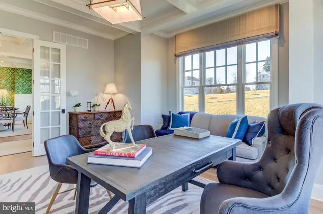 a living room with furniture a table and a large window