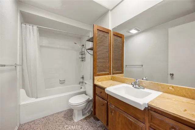 a bathroom with a sink toilet tub and shower