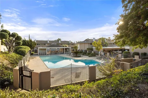 an aerial view of a house with swimming pool and furniture