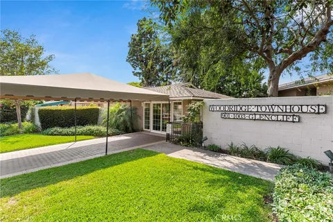 a view of a house with a yard patio and a garden