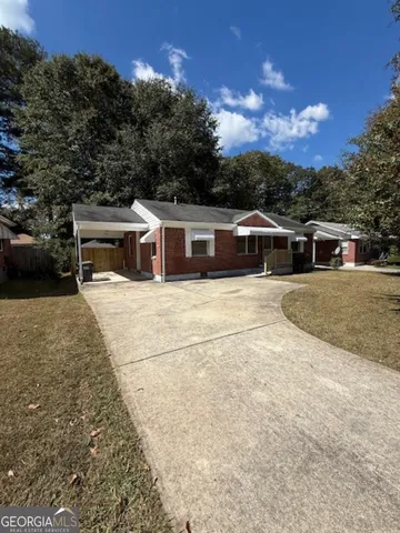 a view of a white house with a yard