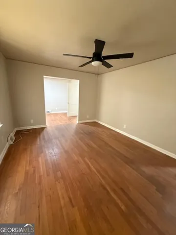 a view of an empty room and wooden floor