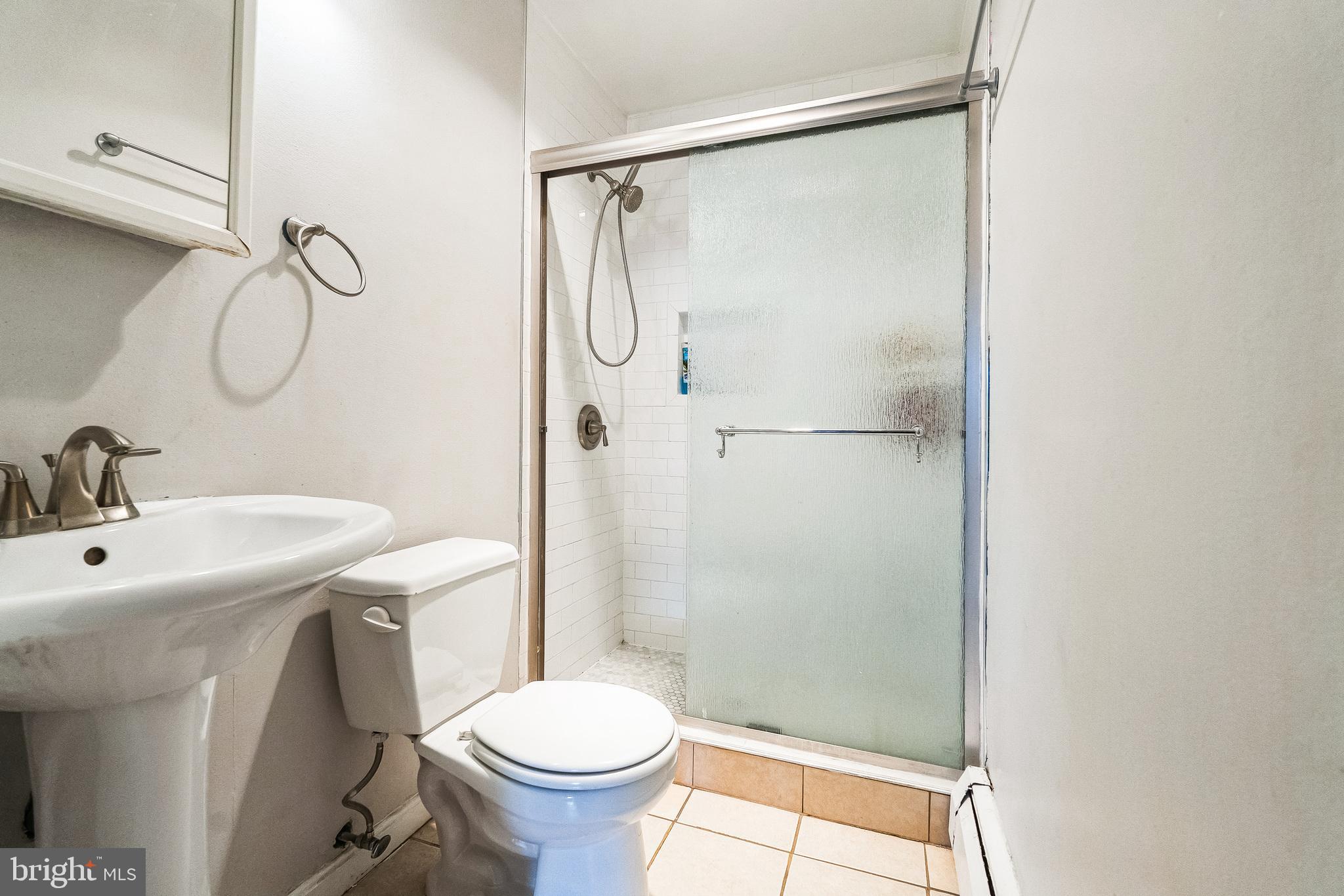 101 7th Street Southeast, Unit 4 Washington, DC 20003 - Photo 6 of 13 a bathroom with a sink toilet and shower