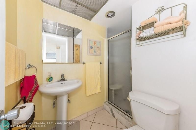 710 North Ocean Boulevard, Unit 1203 Pompano Beach, FL 33062 - Photo 15 of 23 a bathroom with a sink toilet and shower