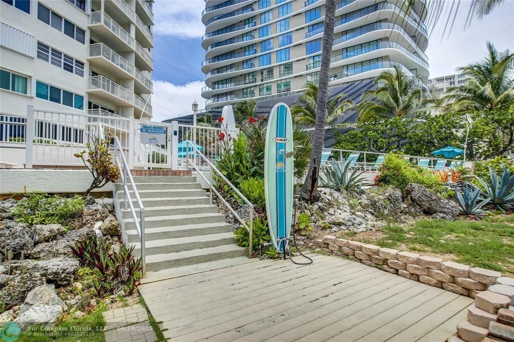 710 North Ocean Boulevard, Unit 1203 Pompano Beach, FL 33062 - Photo 3 of 23 a front view of a house with a yard