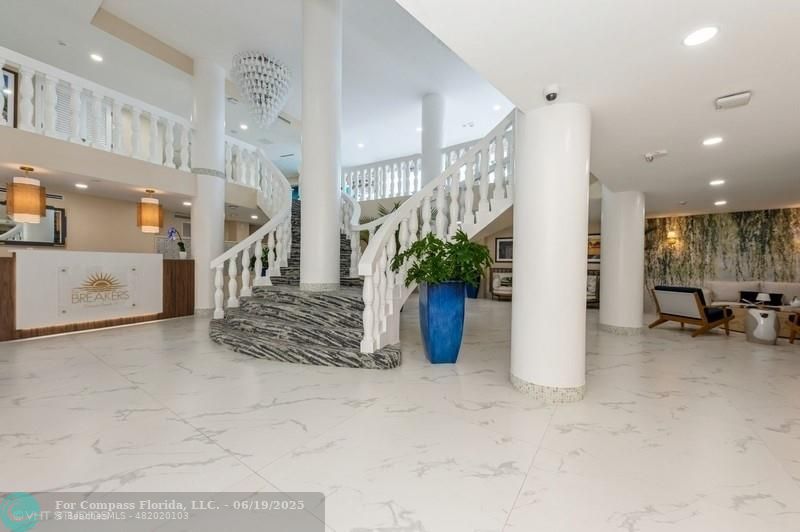 710 North Ocean Boulevard, Unit 1203 Pompano Beach, FL 33062 - Photo 4 of 23 a view of a hallway with dining area and chandelier