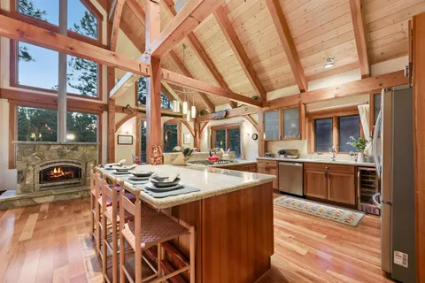 a kitchen that has a stove and a wooden floors