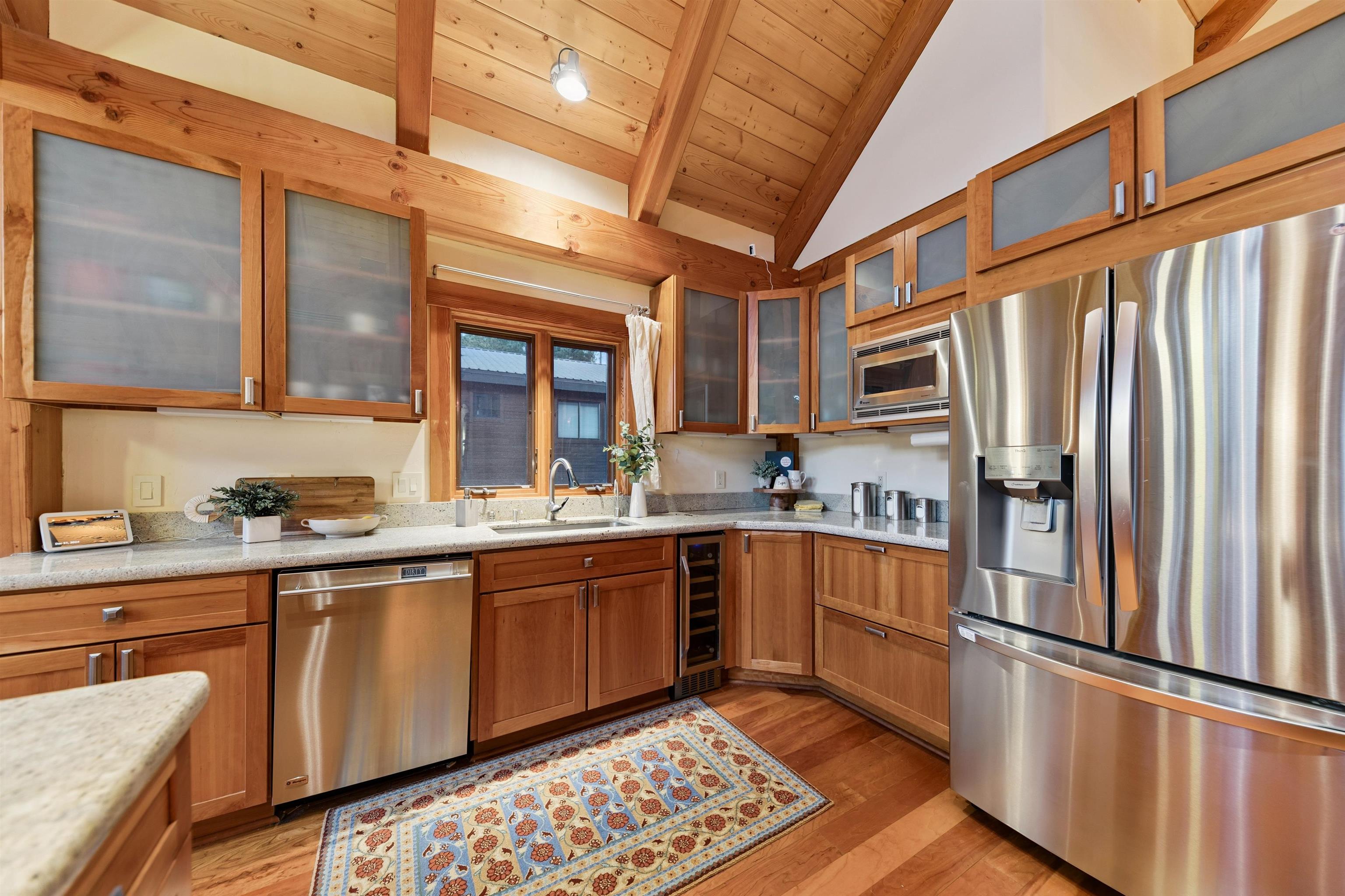 15075 Wolfgang Road Truckee, CA 96161 - Photo 14 of 28 a kitchen with stainless steel appliances granite countertop a refrigerator a sink dishwasher a stove and white countertops with wooden floor