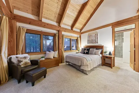 a spacious bedroom with a bed couch and a window