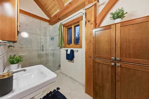 a bathroom with a sink a mirror and a shower