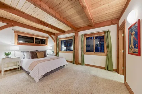 a spacious bedroom with a large bed and a window