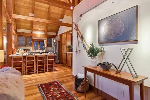 a view of a entryway with furniture and wooden floor