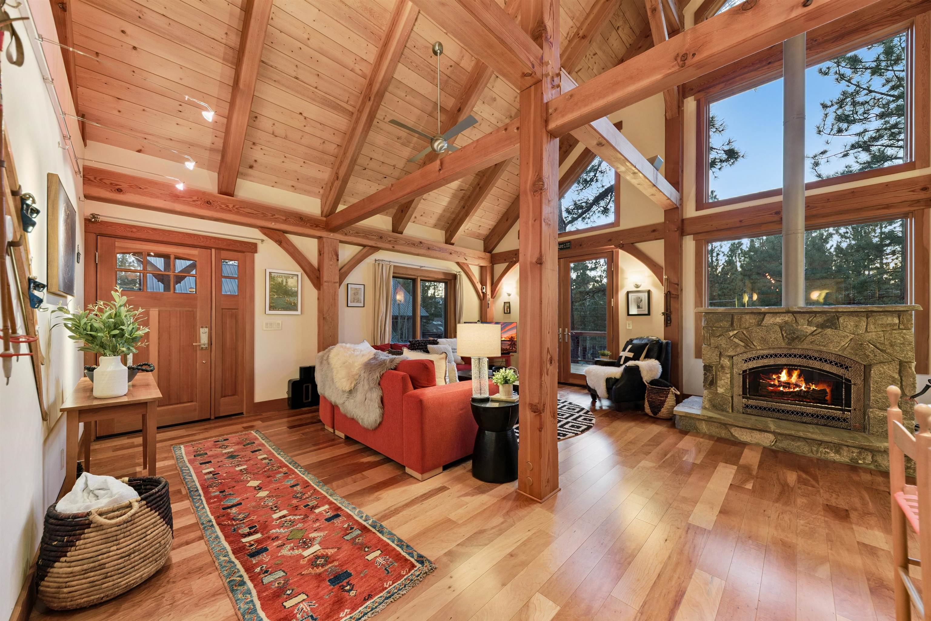 15075 Wolfgang Road Truckee, CA 96161 - Photo 7 of 28 a living room with furniture a fireplace and a floor to ceiling window