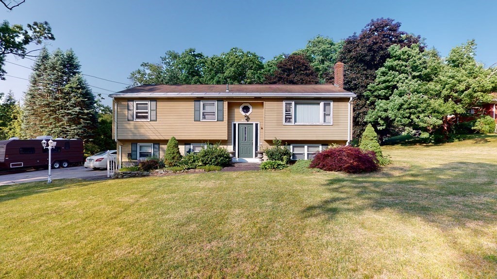 25 Charlton Road Dudley, MA 01571 - Photo 1 of 42 a view of a house with a yard and potted plants