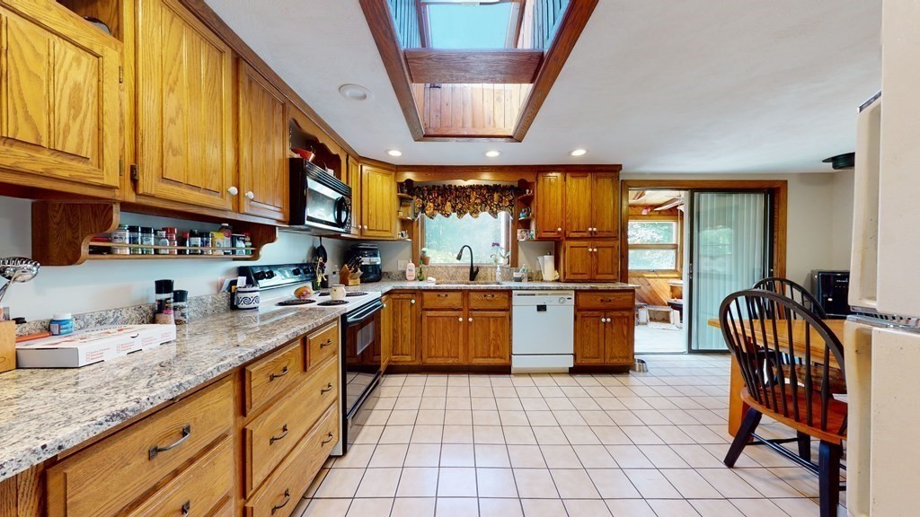 25 Charlton Road Dudley, MA 01571 - Photo 13 of 42 a kitchen with stainless steel appliances granite countertop a sink and cabinets