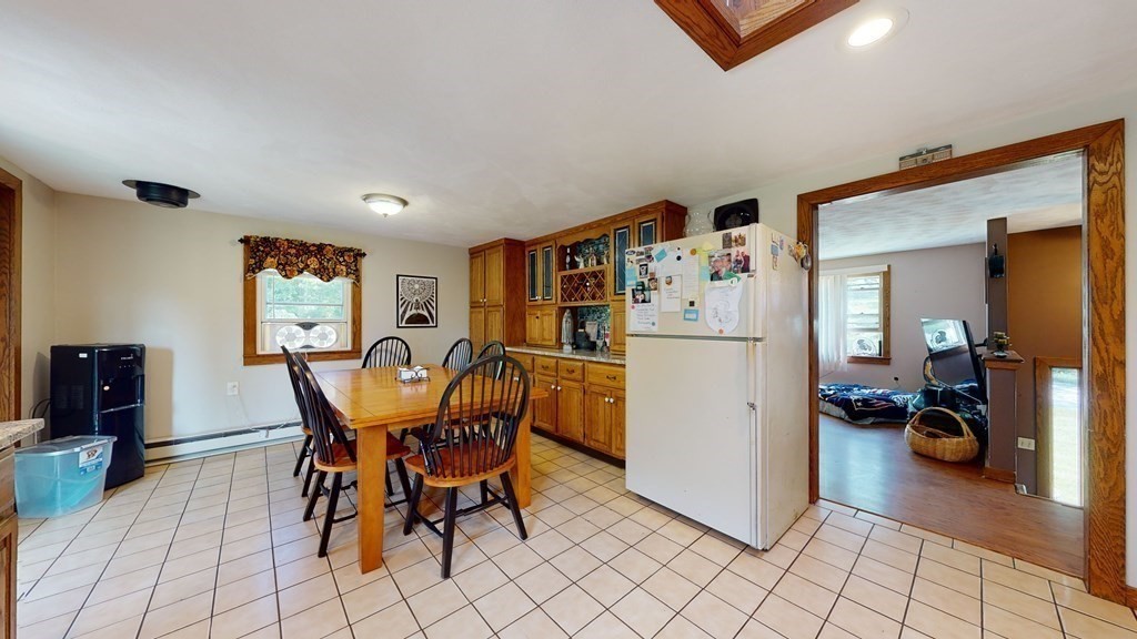 25 Charlton Road Dudley, MA 01571 - Photo 17 of 42 a view of a dining room with furniture and a refrigerator