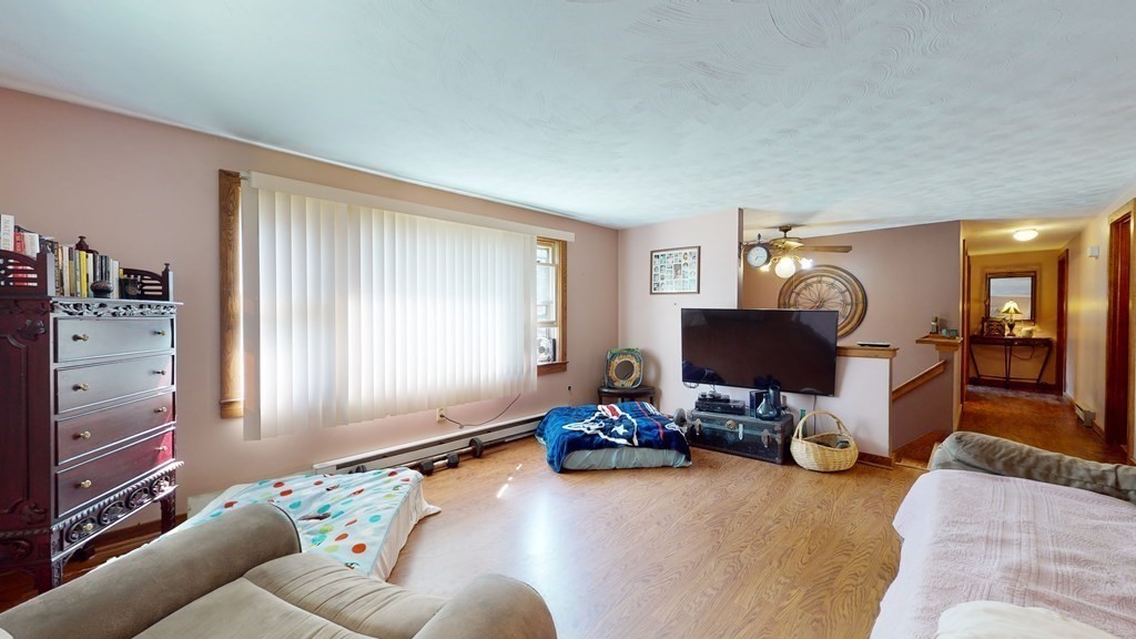 25 Charlton Road Dudley, MA 01571 - Photo 21 of 42 a living room with furniture a window and a flat screen tv