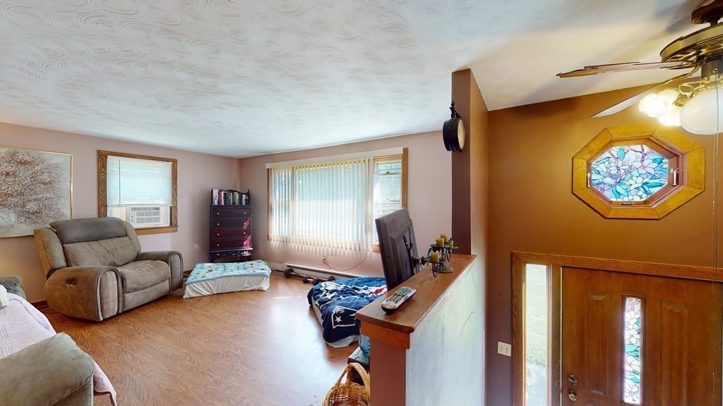25 Charlton Road Dudley, MA 01571 - Photo 22 of 42 a living room with furniture a window and a flat screen tv
