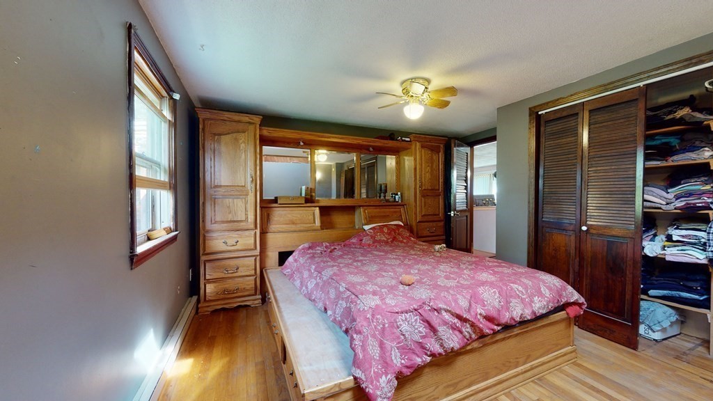 25 Charlton Road Dudley, MA 01571 - Photo 25 of 42 a bedroom with a bed and a chandelier