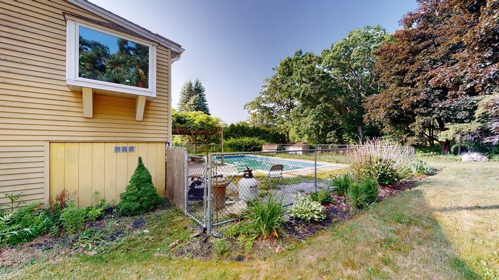 25 Charlton Road Dudley, MA 01571 - Photo 8 of 42 a view of a yard in front of a house with plants and large tree