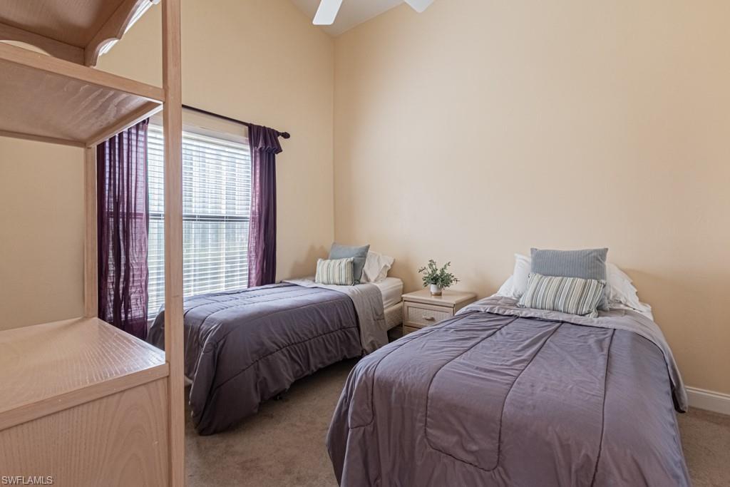 248 St James Way Naples, FL 34104 - Photo 17 of 34 a bedroom with two beds and a large window