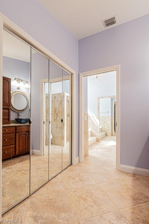 248 St James Way Naples, FL 34104 - Photo 18 of 34 a view of a bathroom with sink mirror and glass door