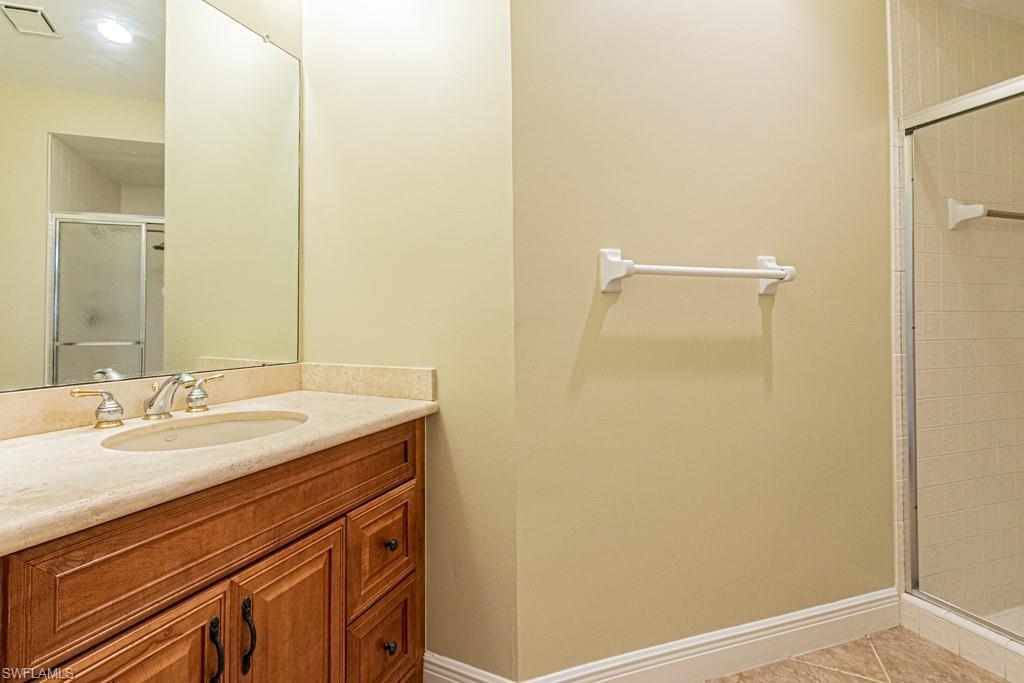 248 St James Way Naples, FL 34104 - Photo 21 of 34 a bathroom with a sink and a mirror