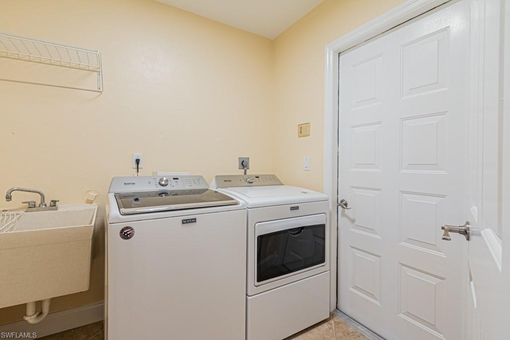 248 St James Way Naples, FL 34104 - Photo 22 of 34 a utility room with dryer and washer