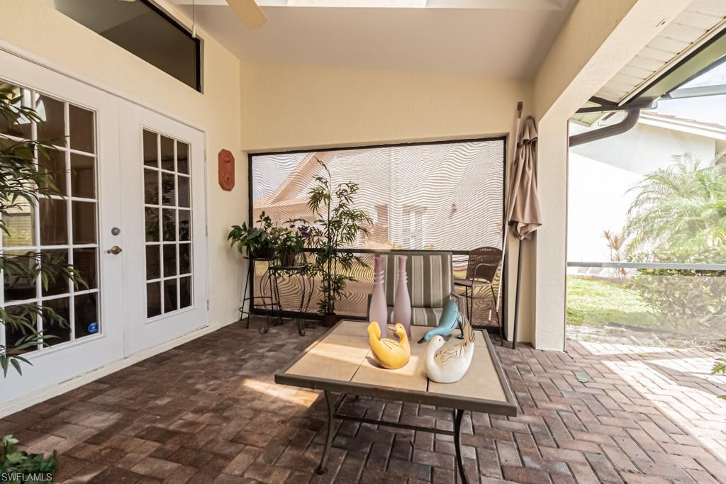 248 St James Way Naples, FL 34104 - Photo 23 of 34 a view of a balcony with chairs and wooden floor