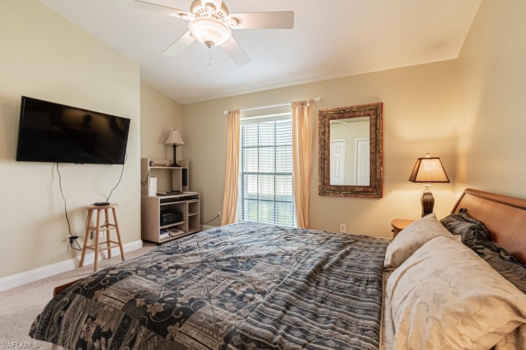 248 St James Way Naples, FL 34104 - Photo 24 of 34 a bedroom with a bed and a flat screen tv