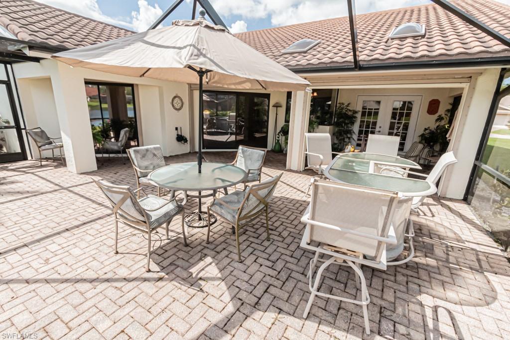 248 St James Way Naples, FL 34104 - Photo 29 of 34 a view of a patio with dining table and chairs
