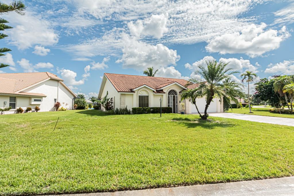 248 St James Way Naples, FL 34104 - Photo 30 of 34 a house with garden area and swimming pool