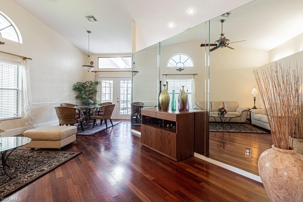 248 St James Way Naples, FL 34104 - Photo 3 of 34 a living room with furniture and a chandelier