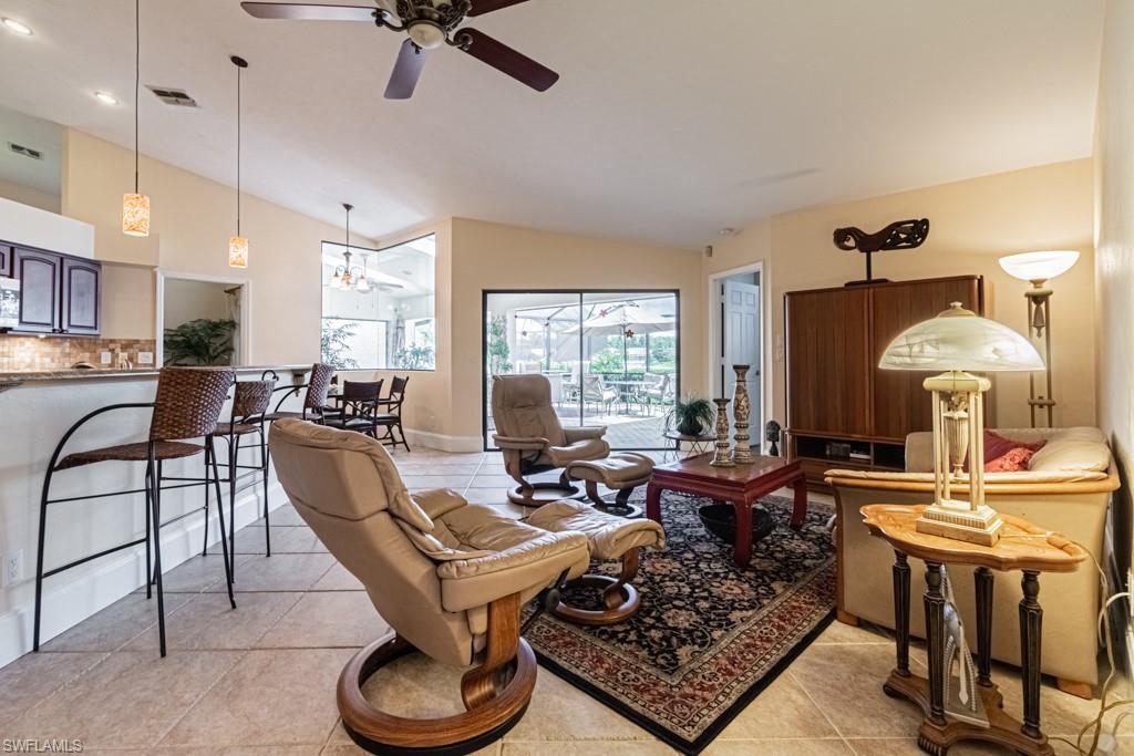 248 St James Way Naples, FL 34104 - Photo 5 of 34 a living room with furniture and a large window