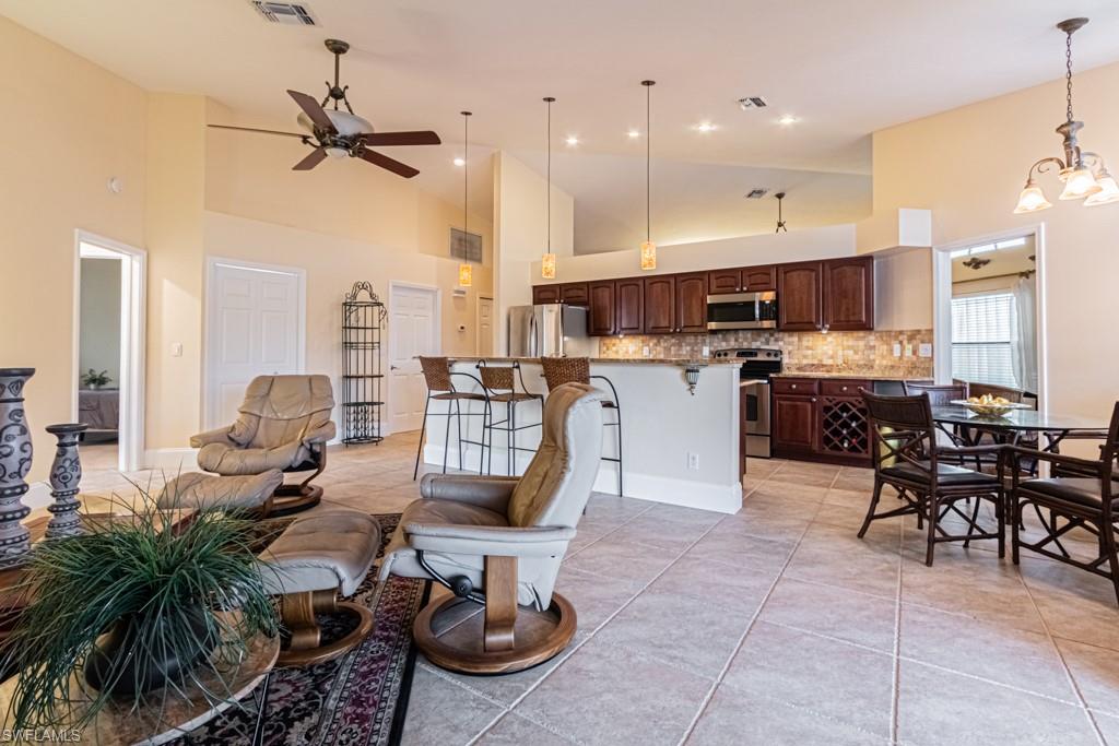 248 St James Way Naples, FL 34104 - Photo 9 of 34 a living room with lots of furniture and kitchen view