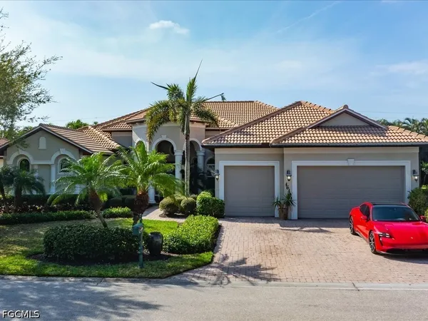 a front view of a house with a garden and plants