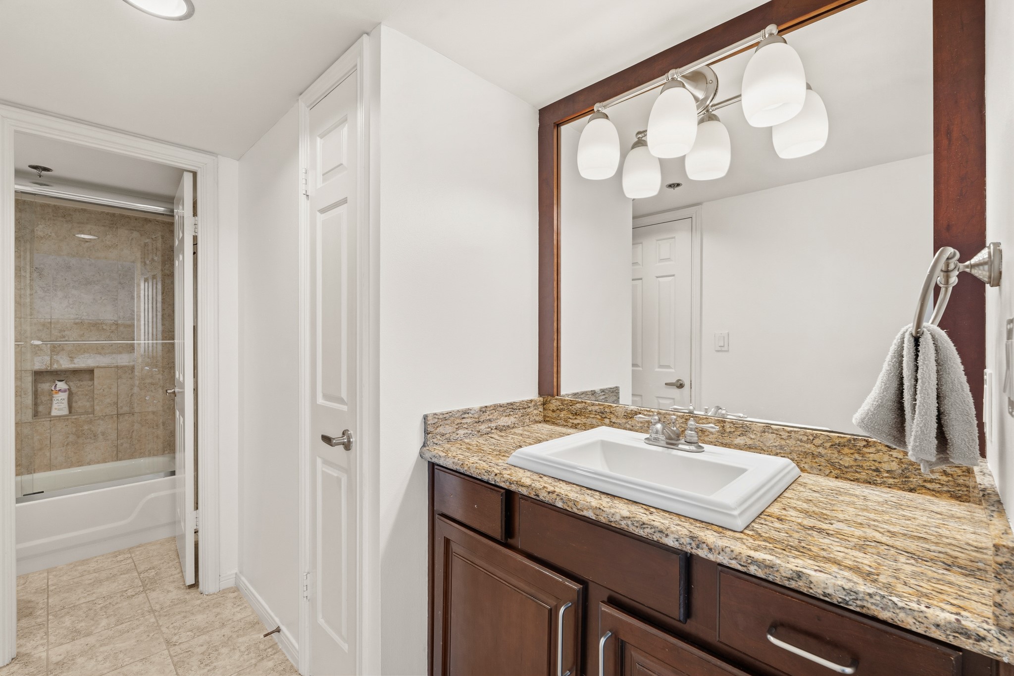 3525 Sage Road, Unit 1204 Houston, TX 77056 - Photo 16 of 25 Primary bathroom featuring a granite-top vanity, mirror, and ample counter space.