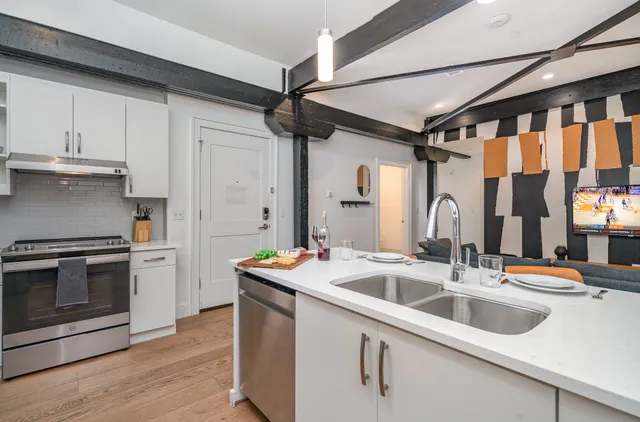 a kitchen that has a sink and a stove top oven