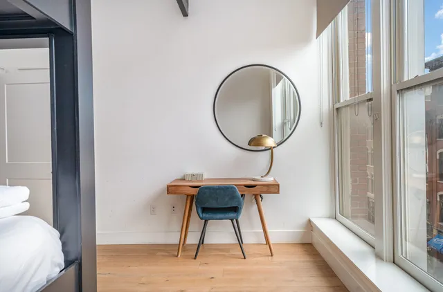 a view of a bedroom with a bed and furniture