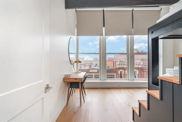 a view of a room with wooden floor and windows