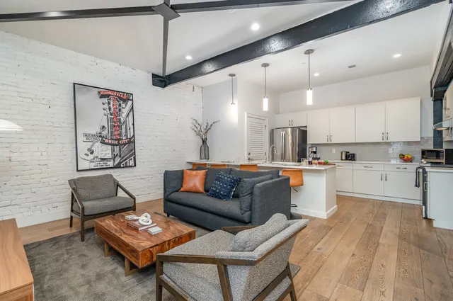 a living room with furniture and kitchen view