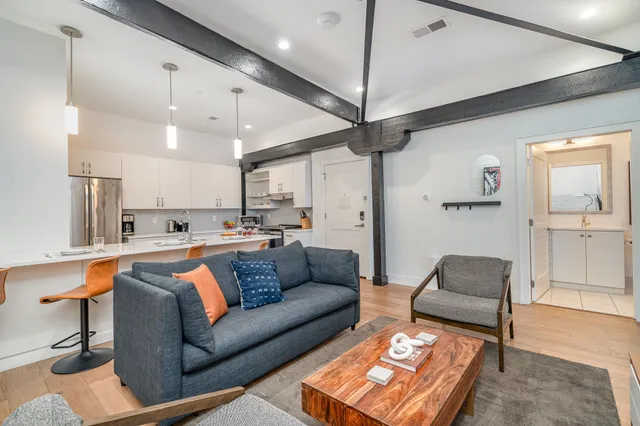 a living room with furniture and a chandelier