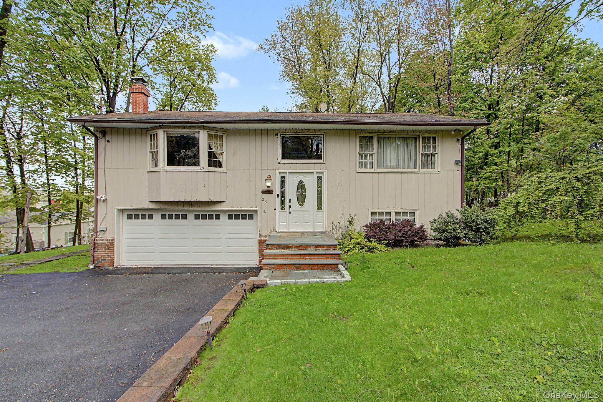 26 Garden Road Mahopac, NY 10541 - Photo 1 of 30 a front view of a house with a garden