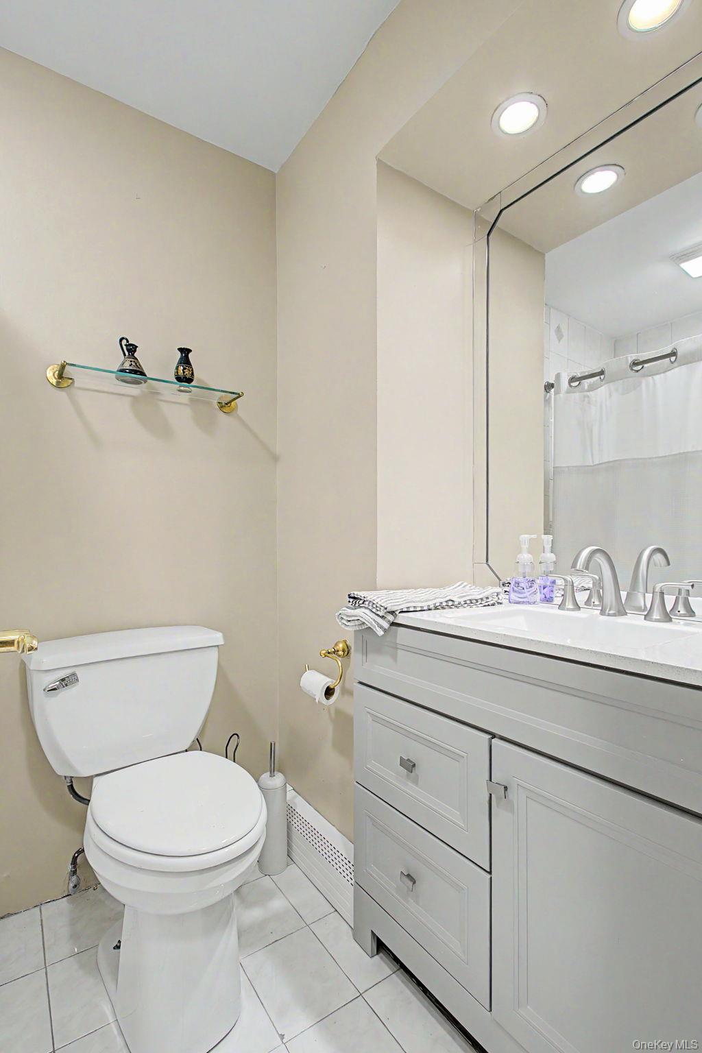 26 Garden Road Mahopac, NY 10541 - Photo 12 of 30 a bathroom with a granite countertop toilet sink and mirror